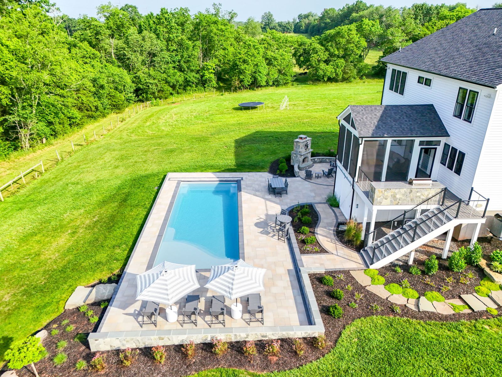 Backyard fiberglass pool and outdoor entertaining area built by Outdoor Solutions in Northern Virginia